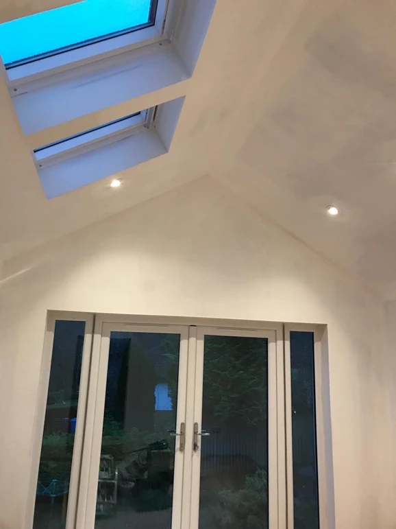 a white room with skylights and windows