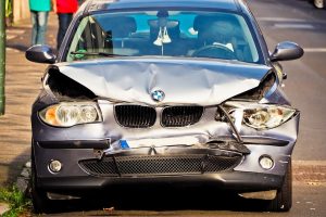 a front end of a car with a damaged front end