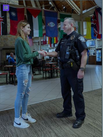 a woman shaking hands with a police officer