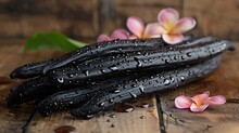 a black vegetable with water drops on it