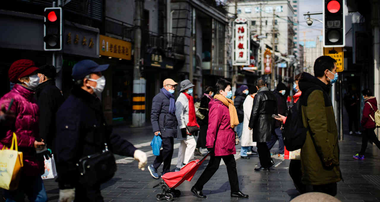 a group of people walking on a street with masks