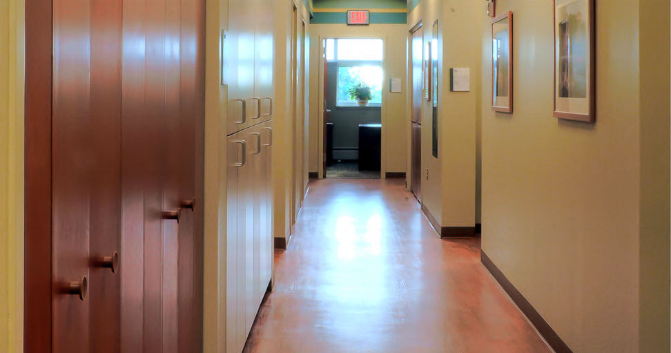 a hallway with lockers and a sign