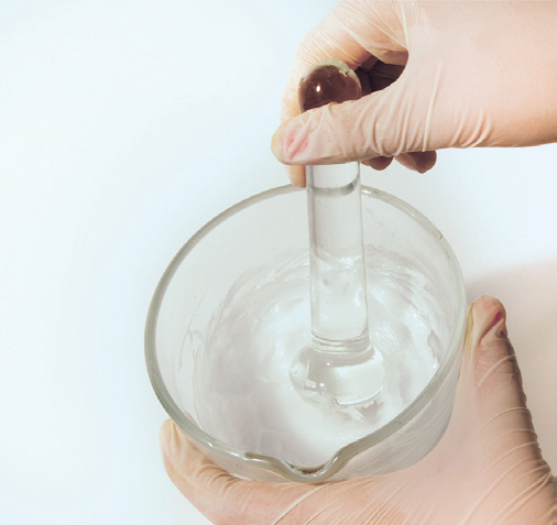 a person holding a glass beaker