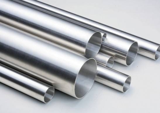 several metal pipes on a white surface