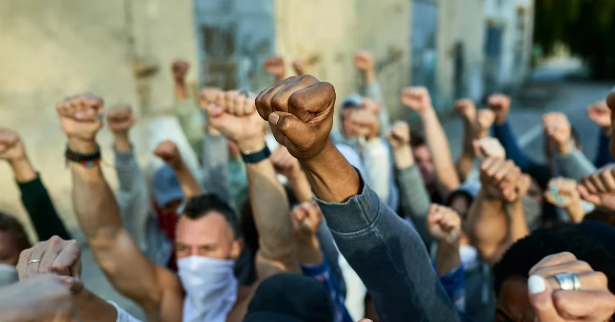 a group of people with fists raised