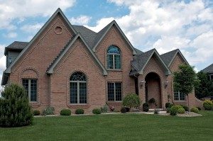 a large brick house with a lawn