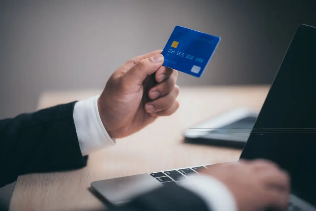a person holding a credit card