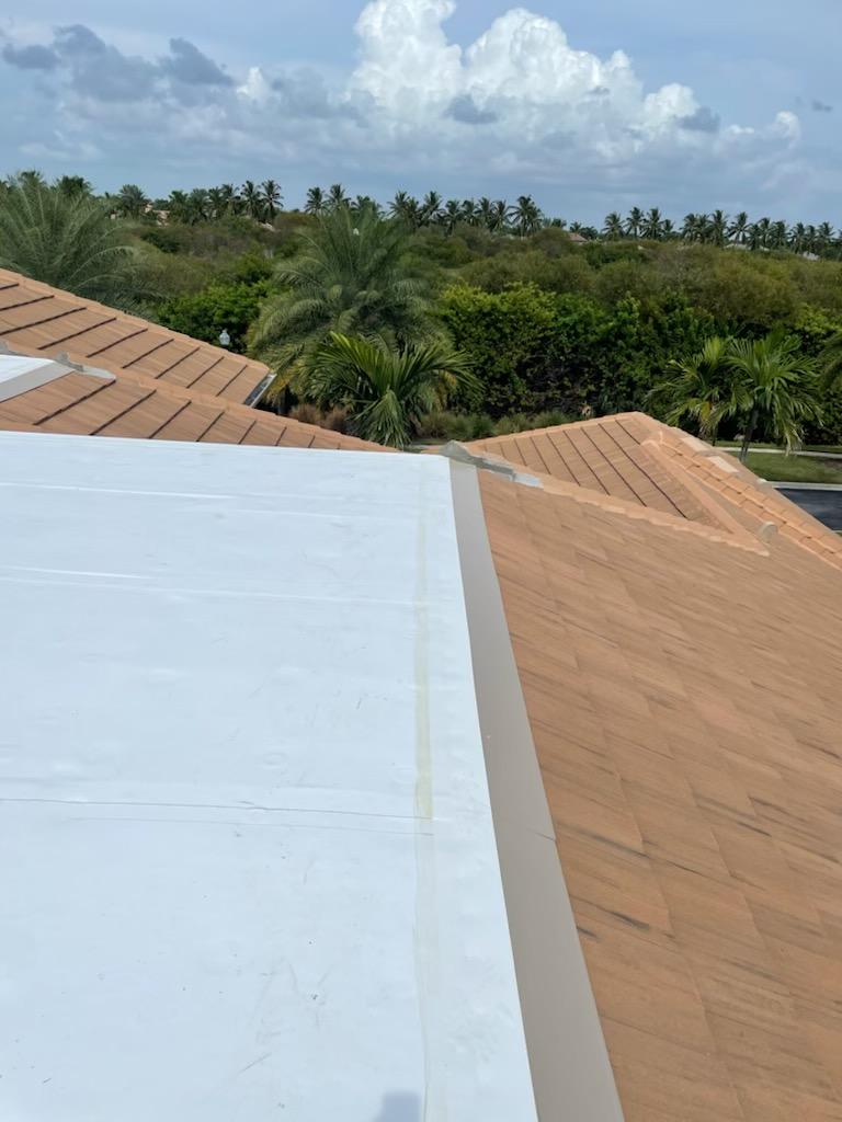 a roof of a house with trees in the background