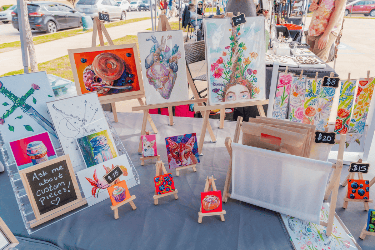 art on easels with other art items on the stand
