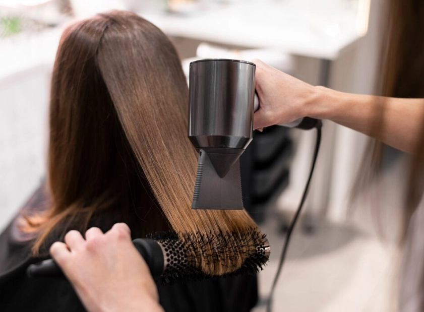 a person using a hair dryer