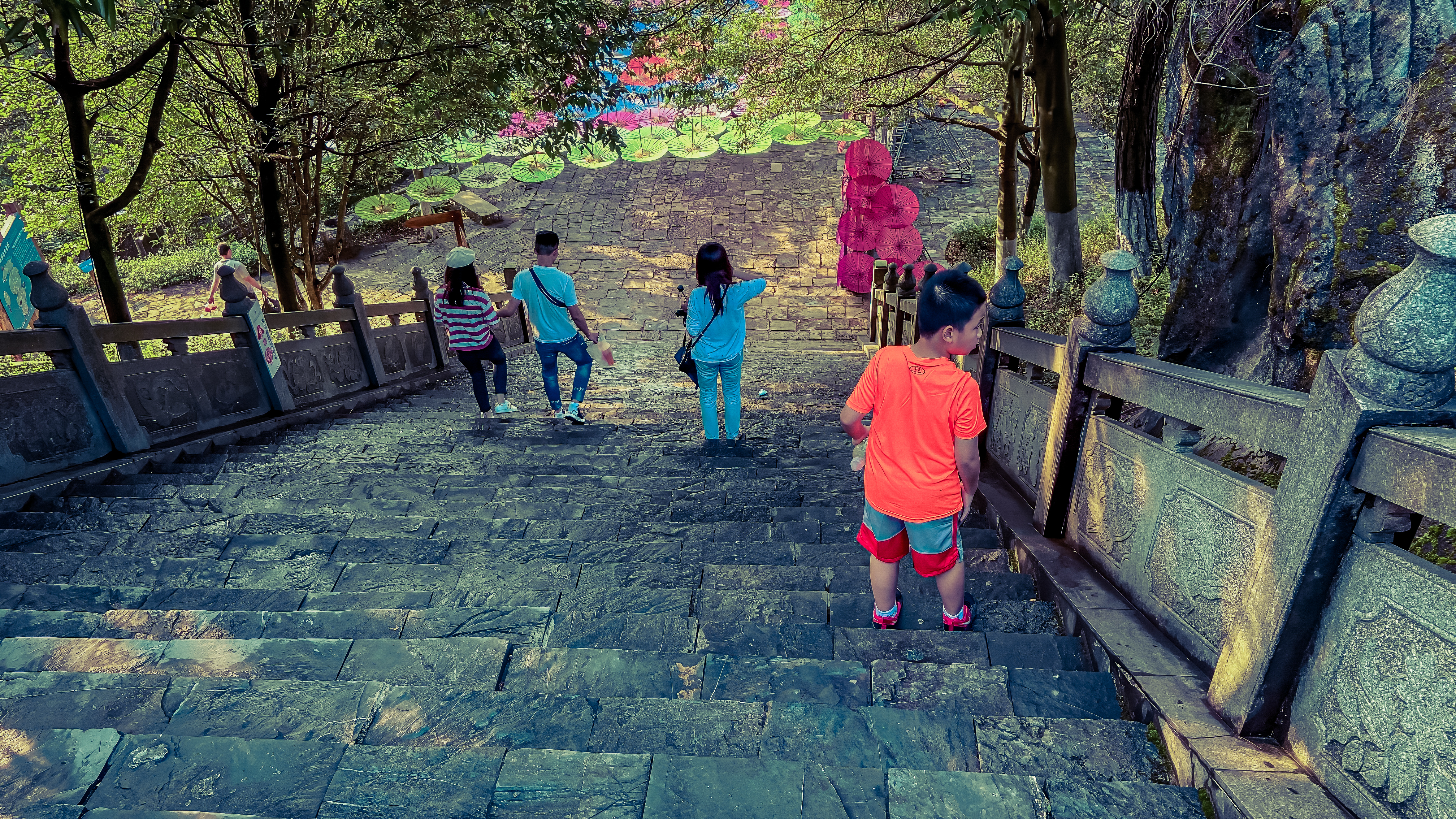 a group of kids walking up a stone staircase