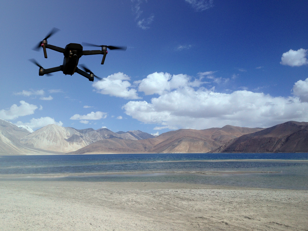 a drone flying over a beach