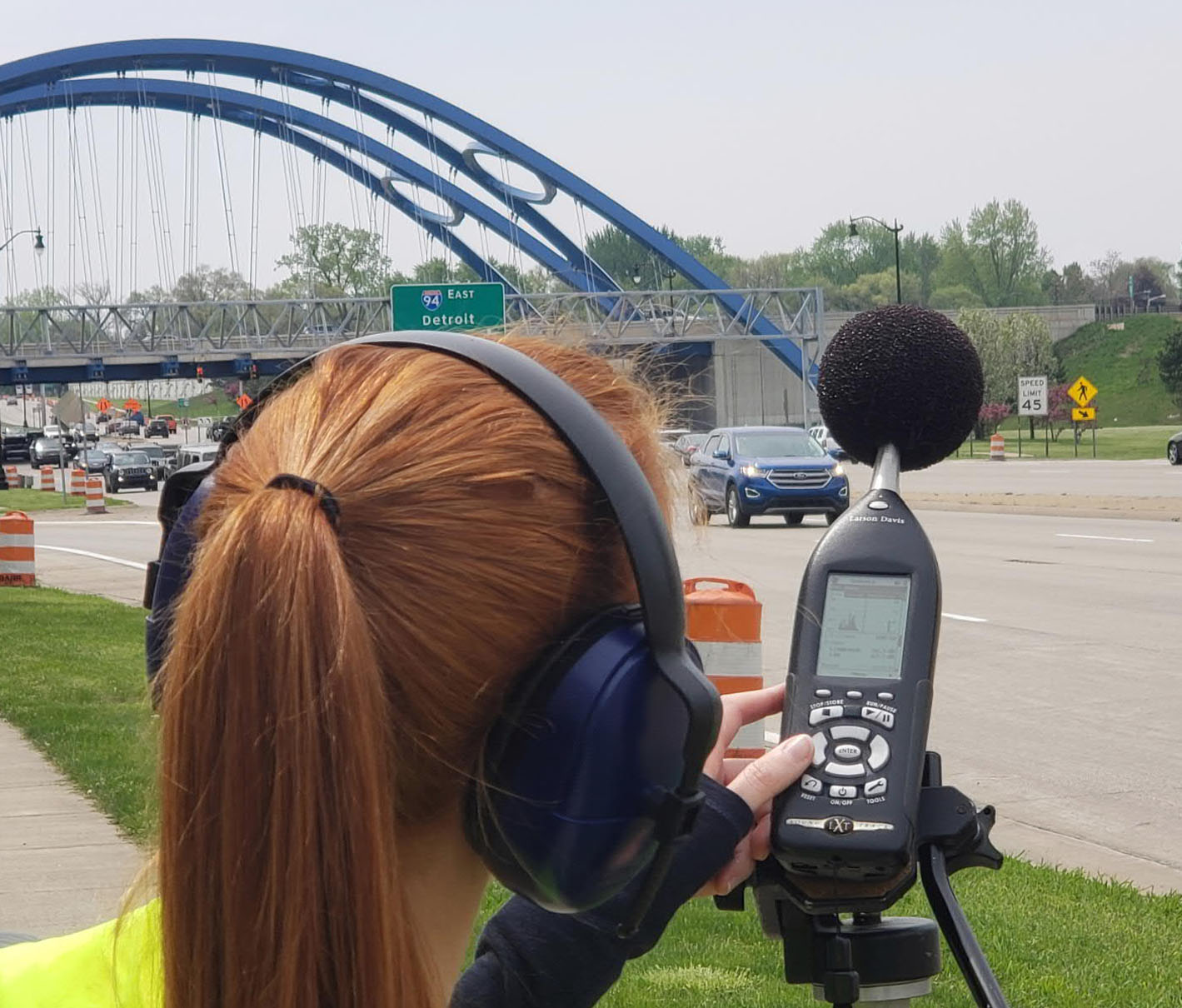 a woman wearing headphones and holding a phone