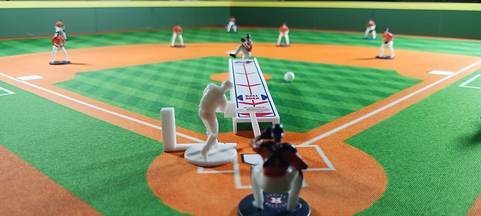 a toy baseball game on a field