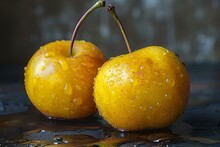 two yellow apples with water droplets on them