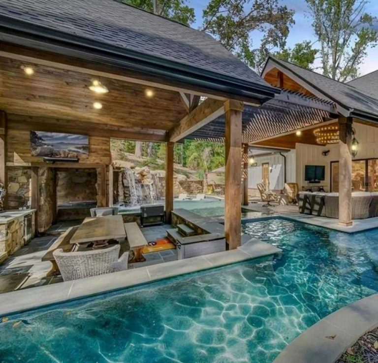 a pool and a house with a covered patio