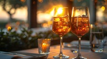 two glasses of ice tea and candle on a table