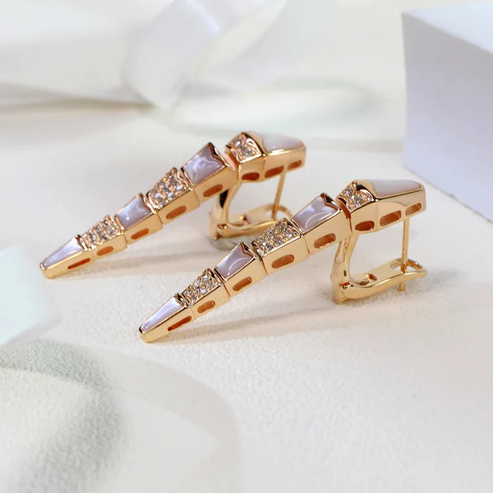 a pair of gold earrings with diamonds and gemstones