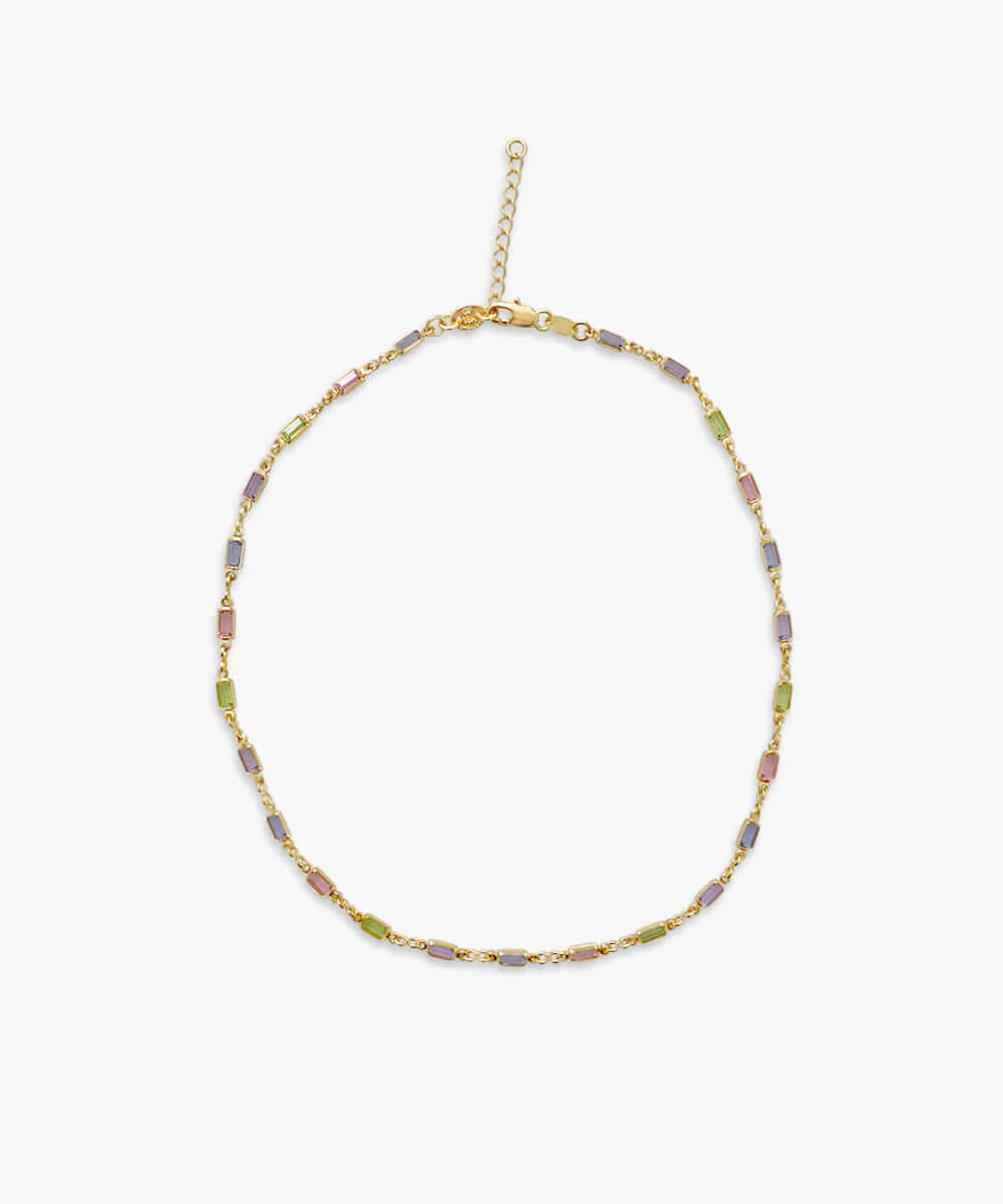 a gold necklace with colorful stones