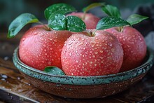 a bowl of apples with water droplets on them