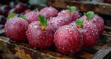 a group of red fruit with water drops on them