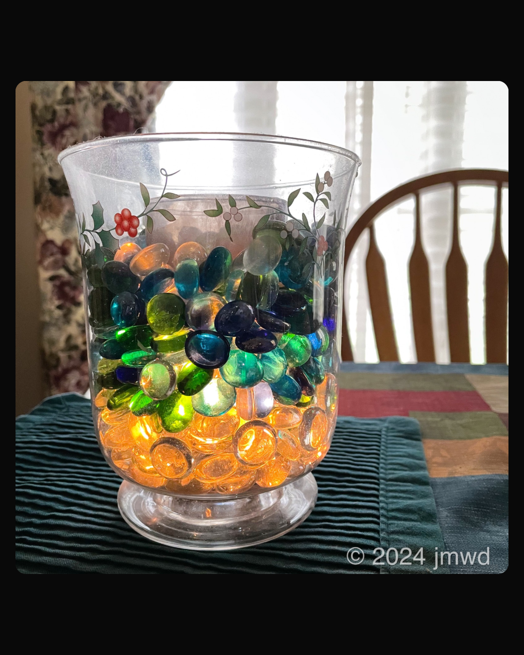 a glass vase filled with colorful pebbles