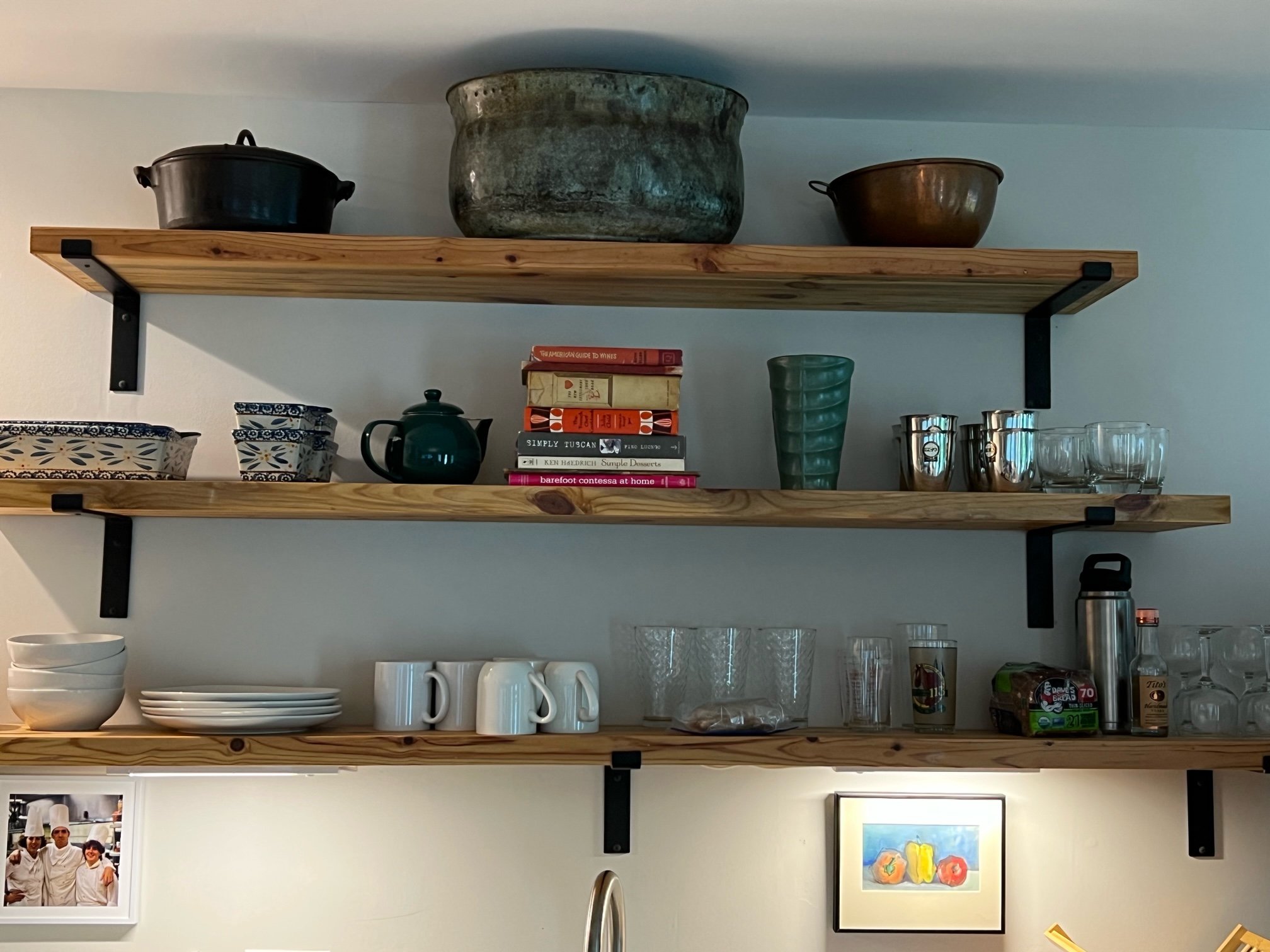 shelves with books and pots on it