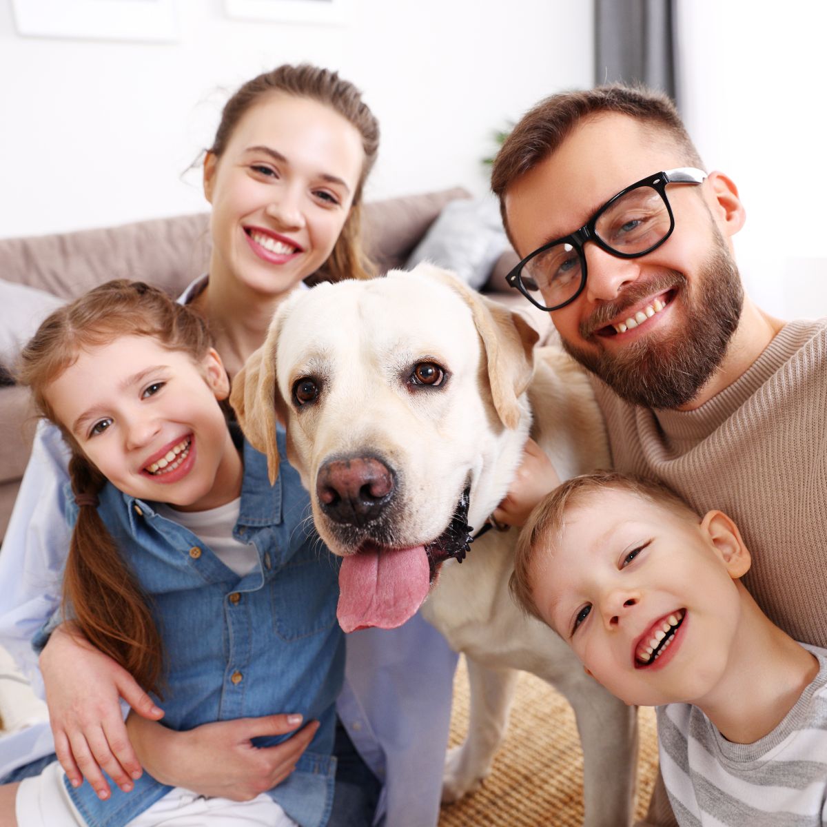 a family posing for a picture with a dog