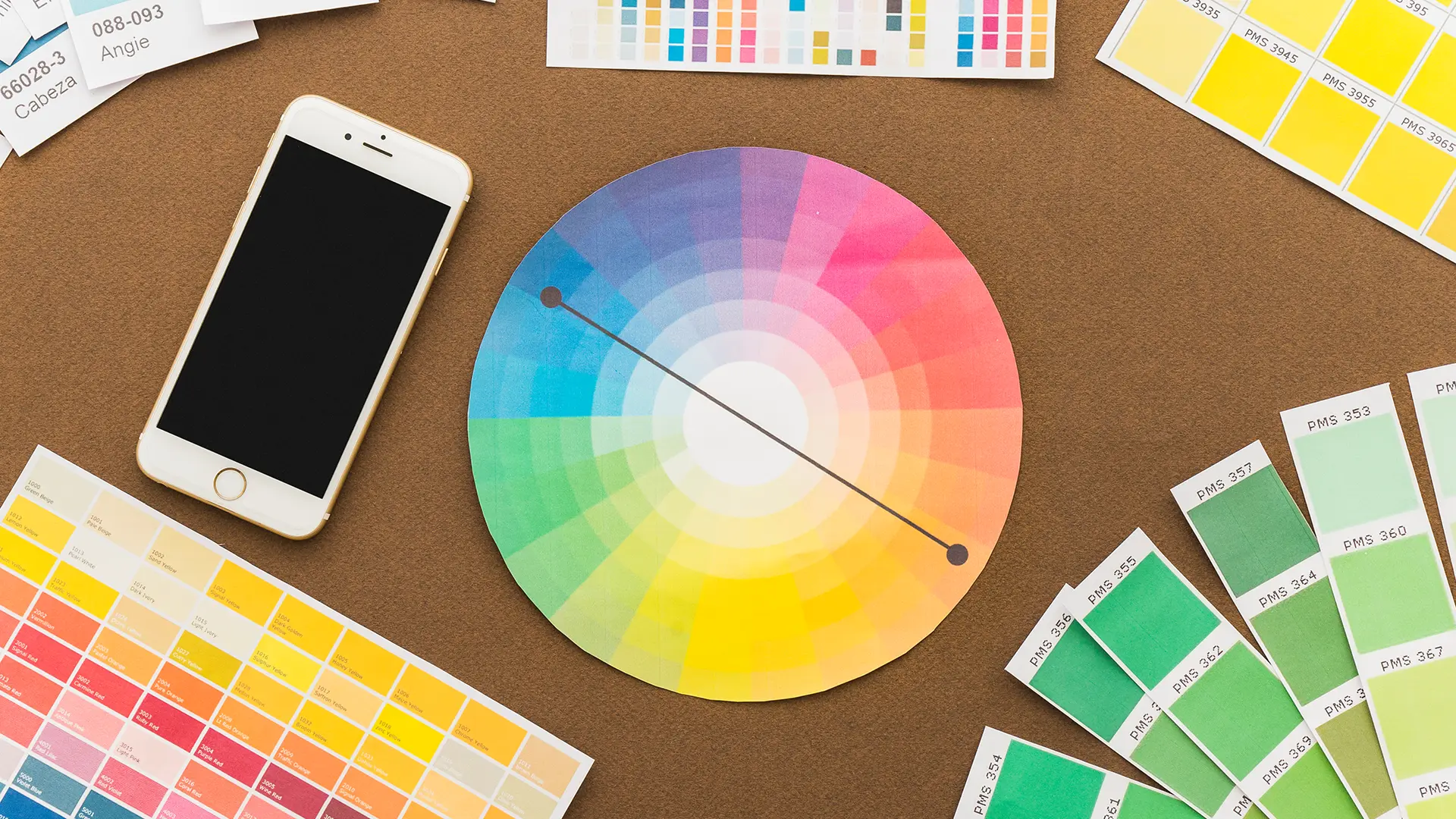 a circular paper with a color wheel and a phone on a table