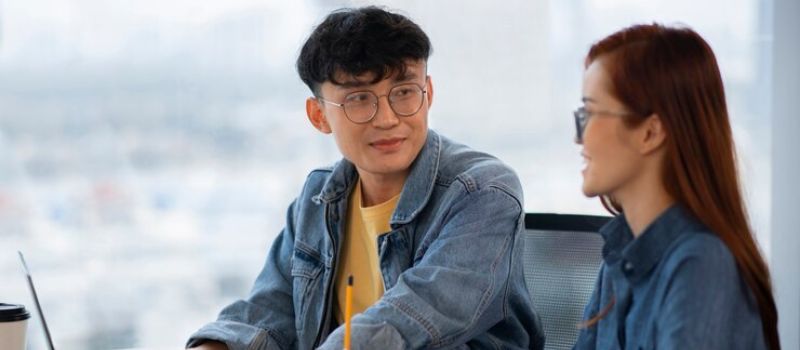 a man in glasses and a denim jacket