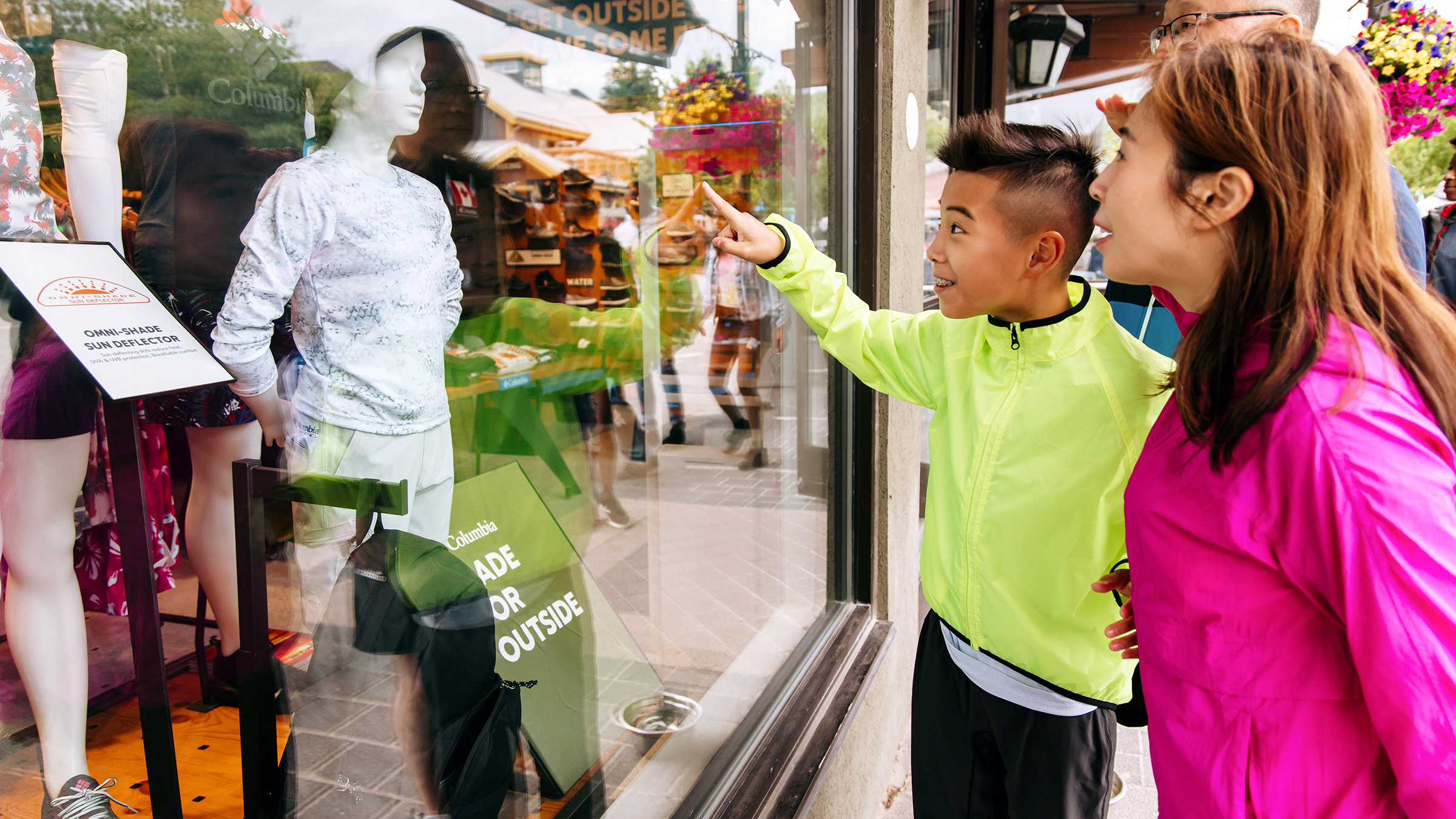 a boy pointing at a store window