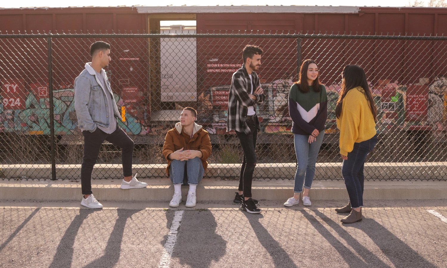 a group of people standing next to a fence