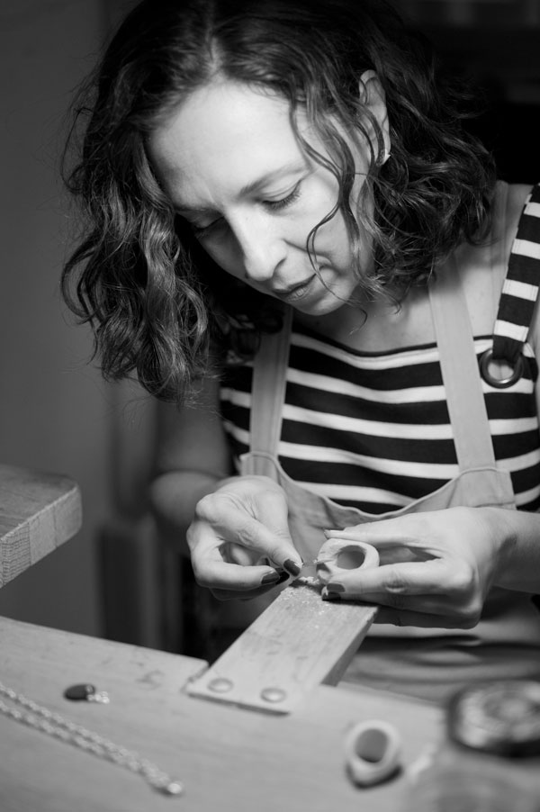 a woman working on a piece of wood