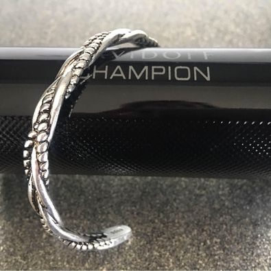 a silver bracelet on a black device