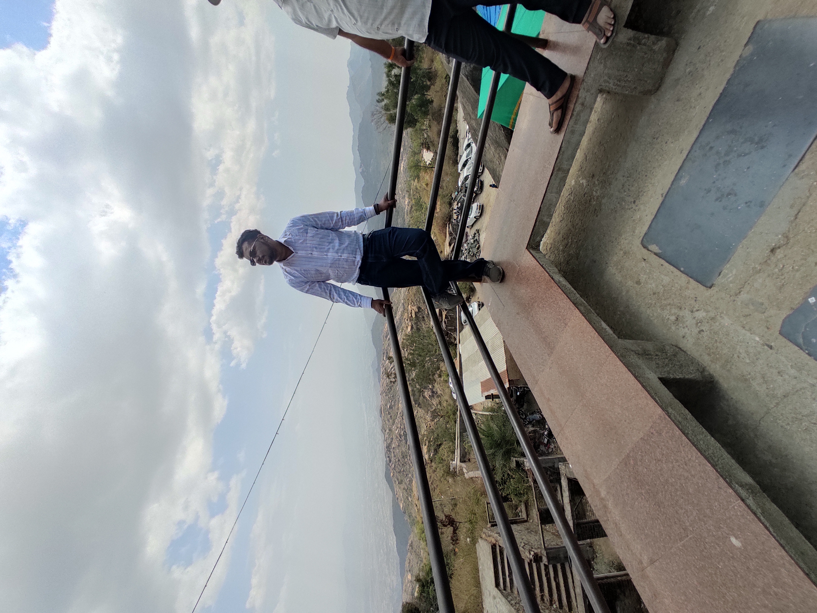 two men standing on a railing