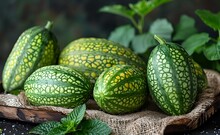 a group of watermelons on a cloth