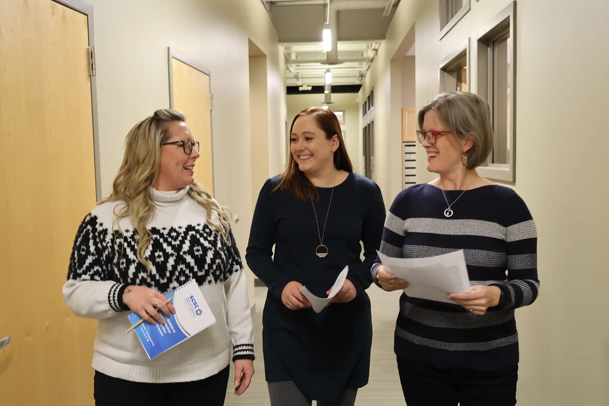 a group of women standing in a hallway