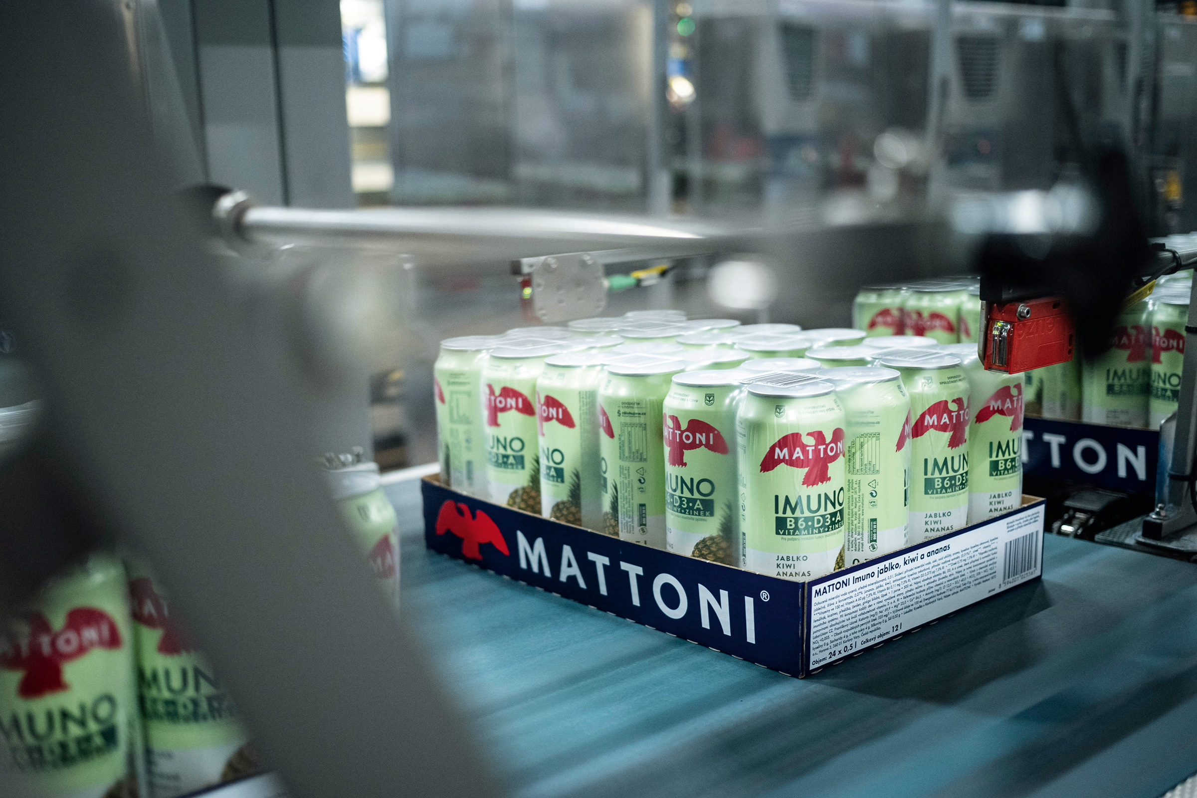 a group of cans on a conveyor belt
