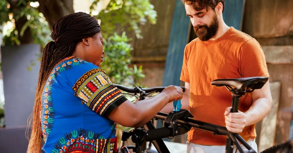 a man and woman fixing a bike