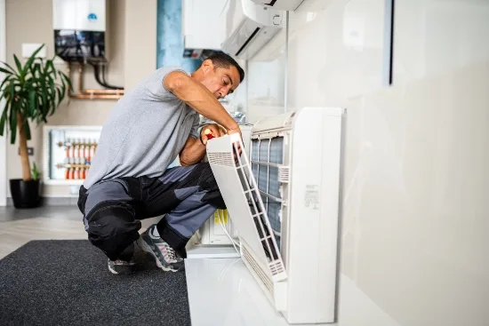 a man fixing a air conditioner