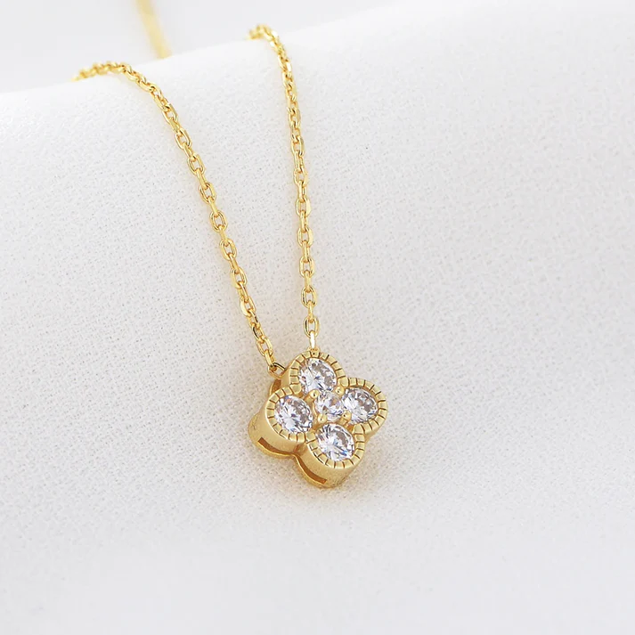 a gold necklace with diamonds on it