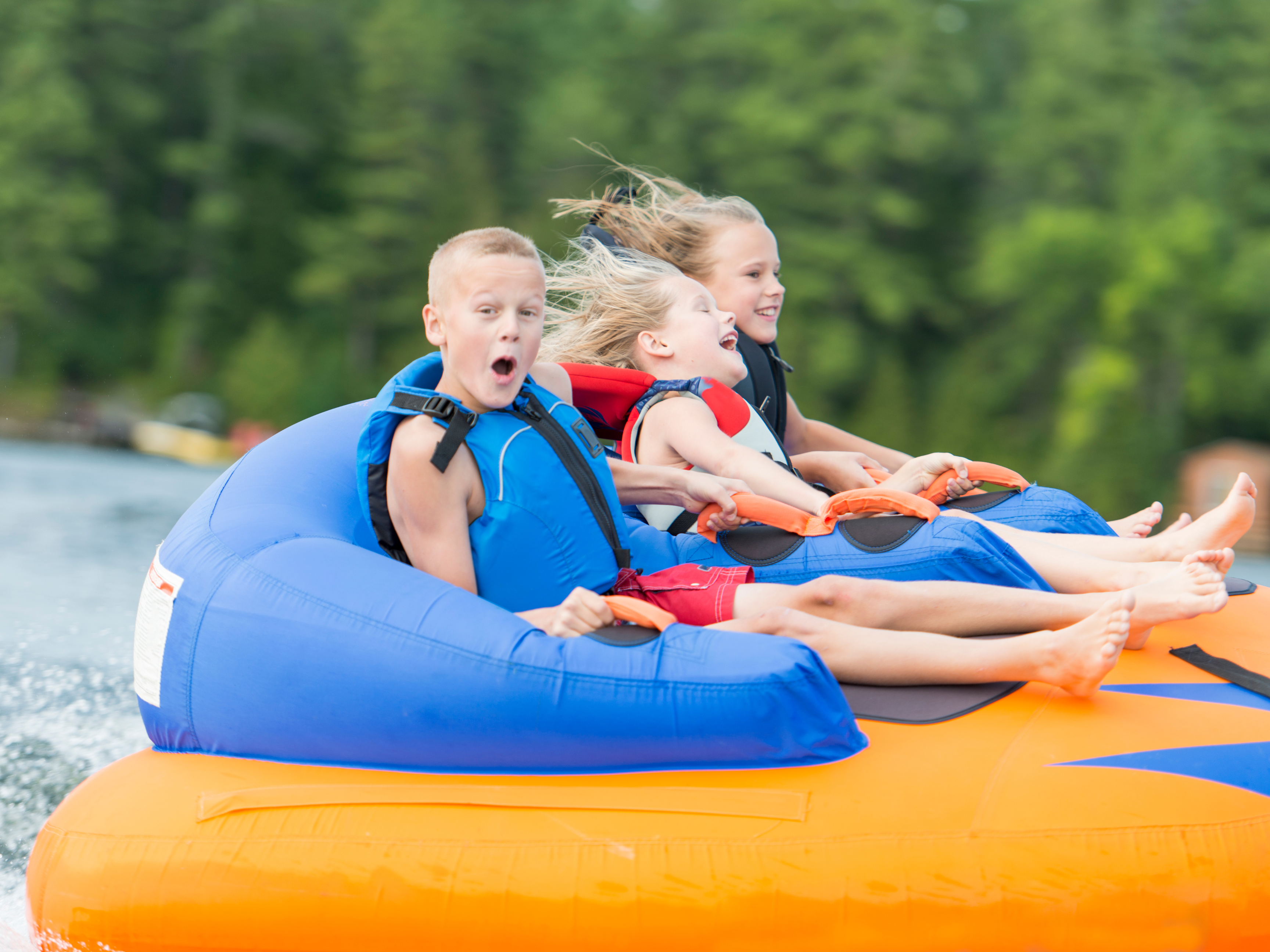 a group of kids on an inflatable raft