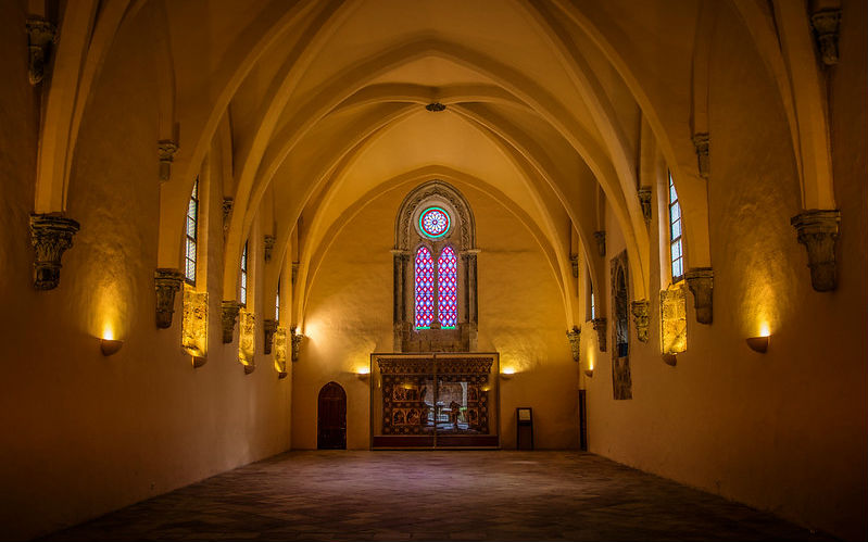 a large room with arched ceiling and stained glass windows