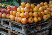 a pile of oranges on a pallet