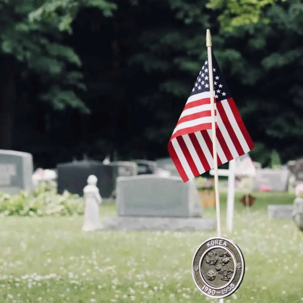 a flag and a coin in a cemetery