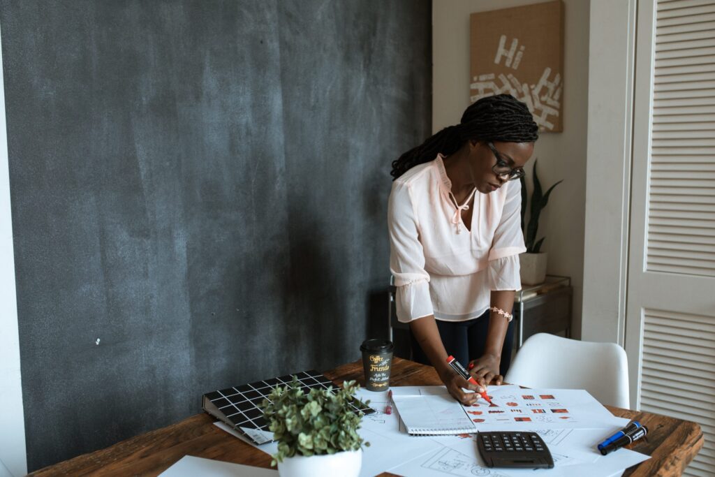 a woman writing on papers