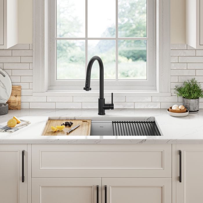 a kitchen sink with a black faucet