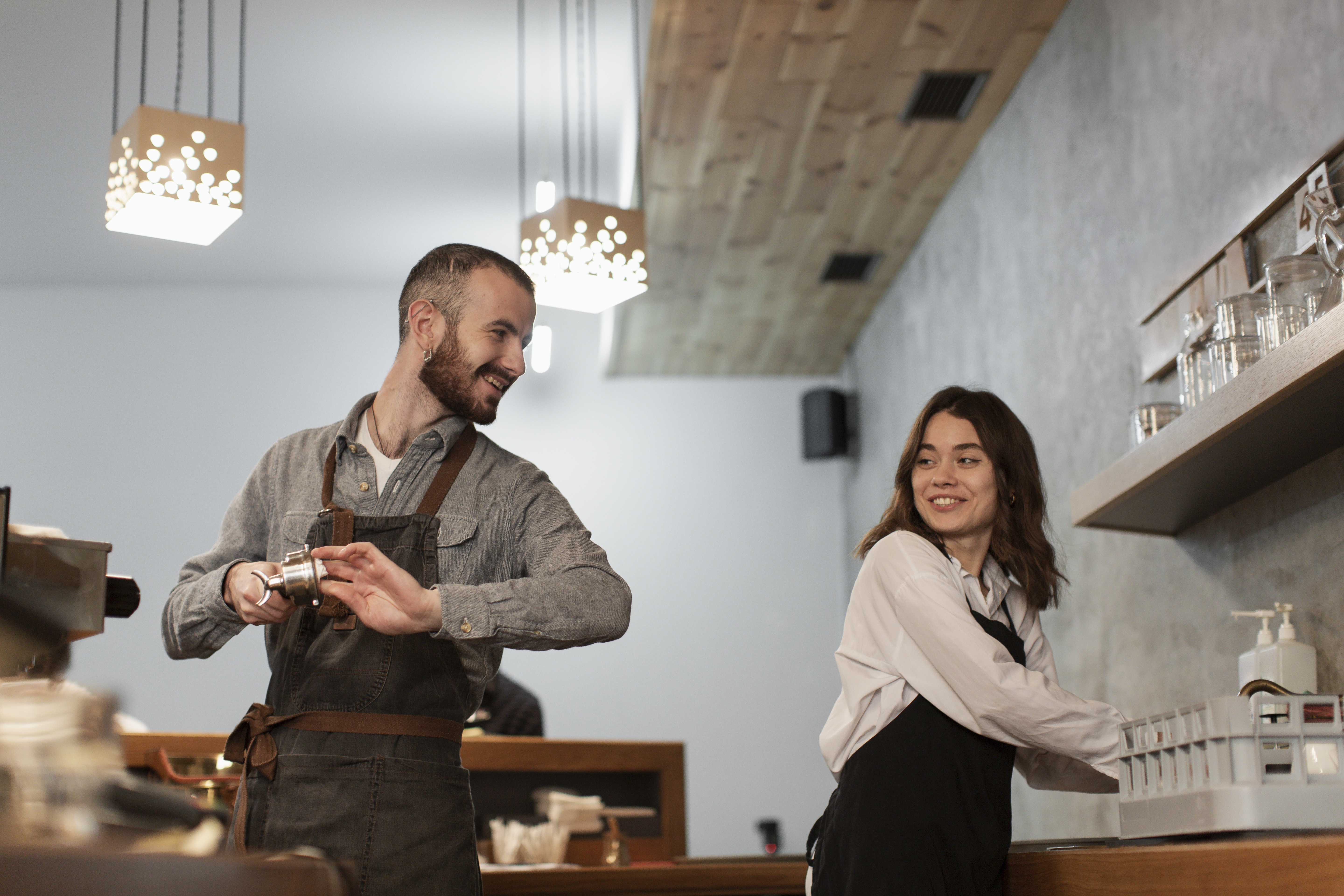 a man and woman standing in a coffee shop