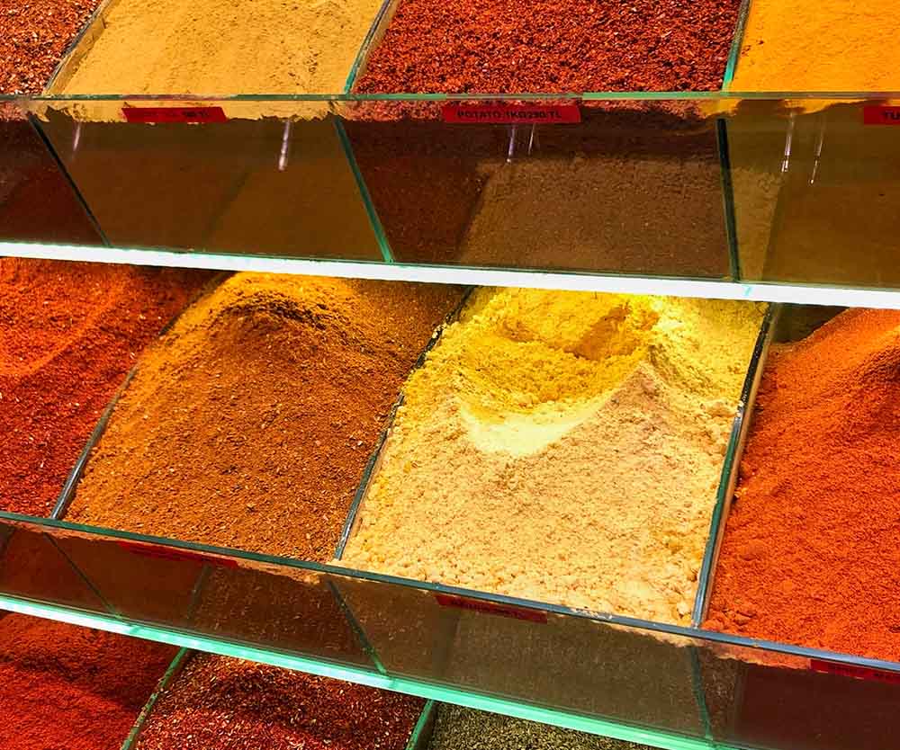 a shelf with different colored powders