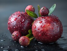 a group of red fruits with water droplets on them